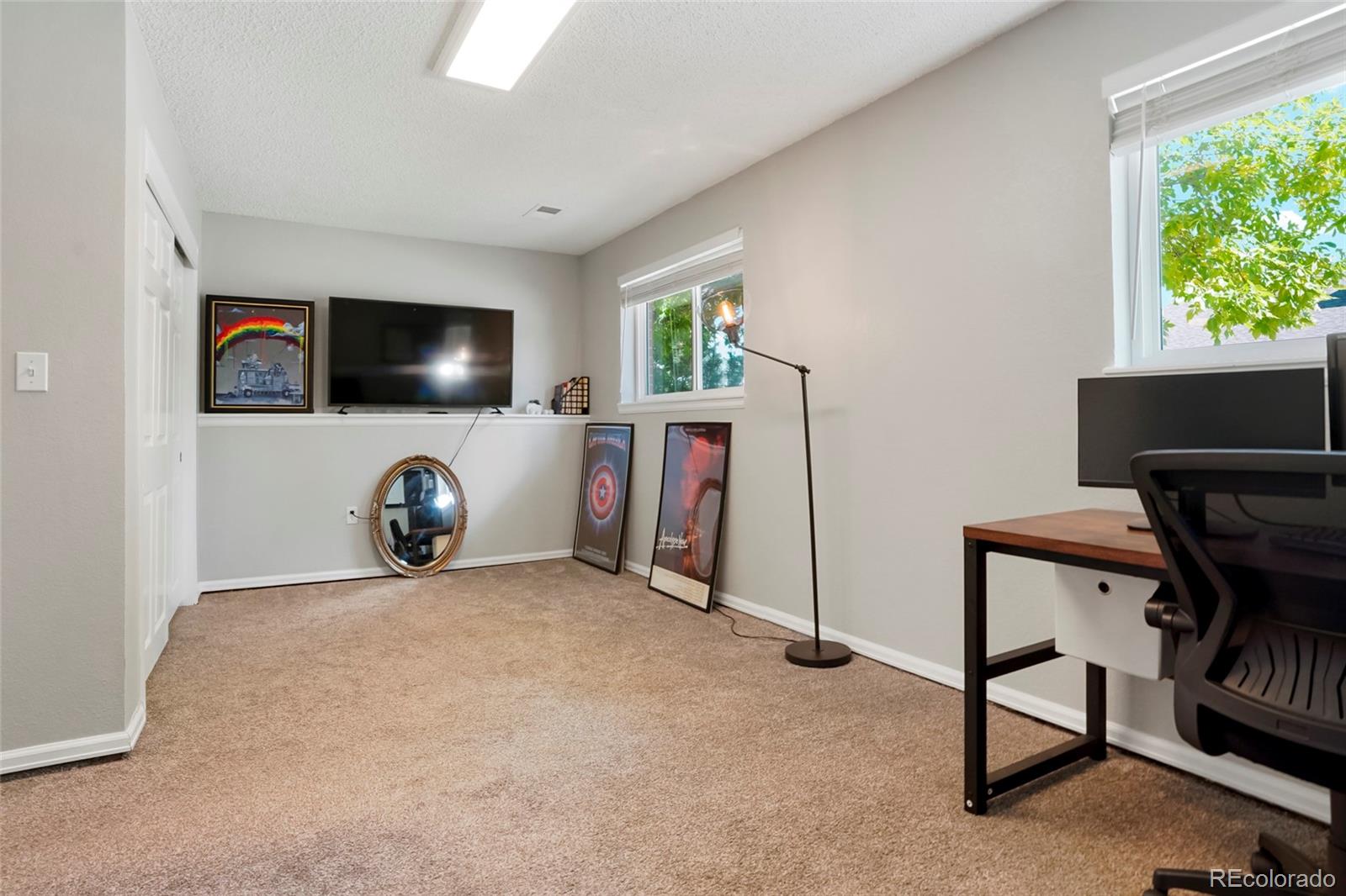 9191 Hickory Circle Highlands Ranch, CO 80126 - Photo 20 of 27 a view of a livingroom with furniture and a flat screen tv