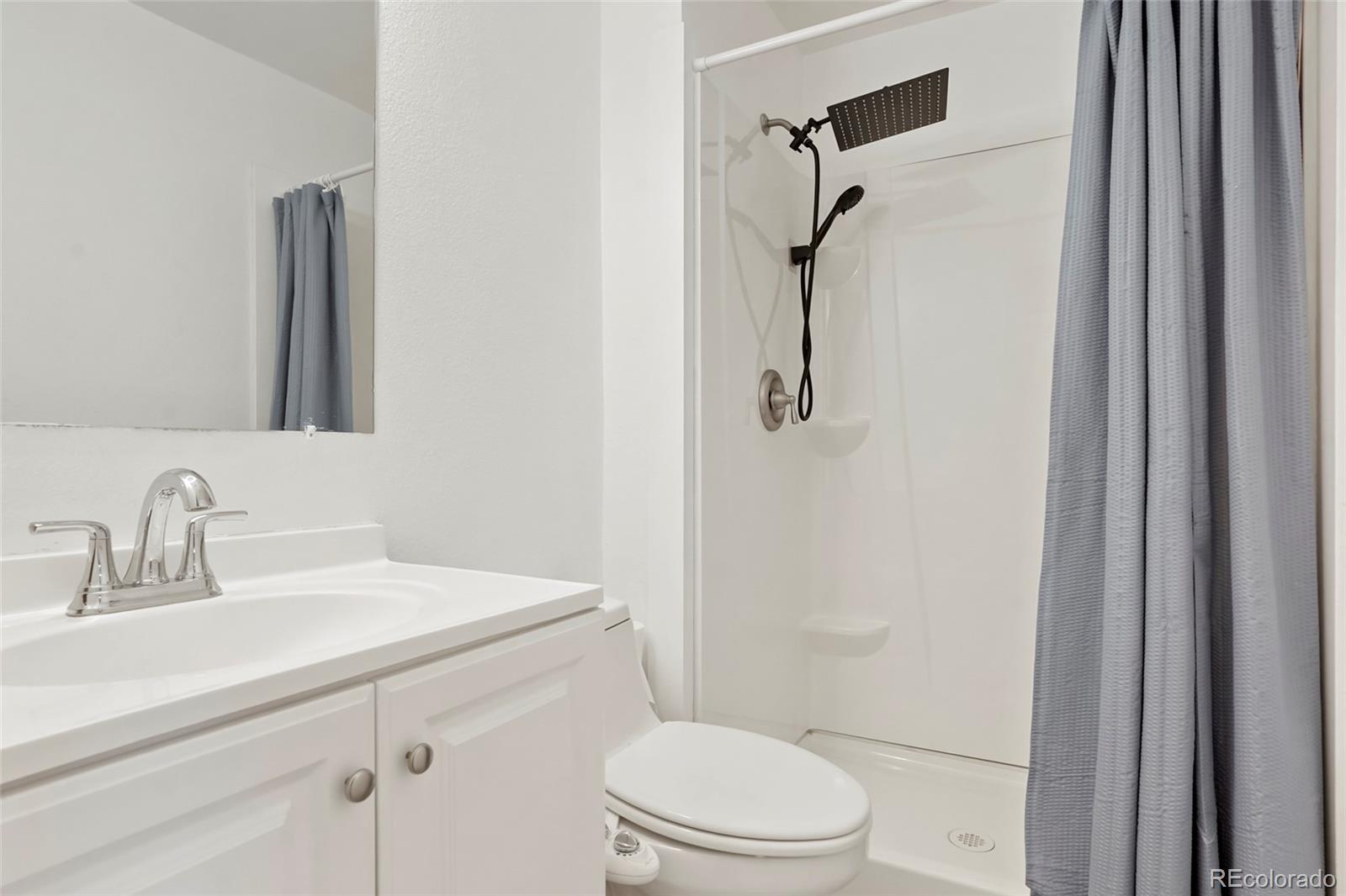 9191 Hickory Circle Highlands Ranch, CO 80126 - Photo 21 of 27 a bathroom with a granite countertop sink toilet and shower