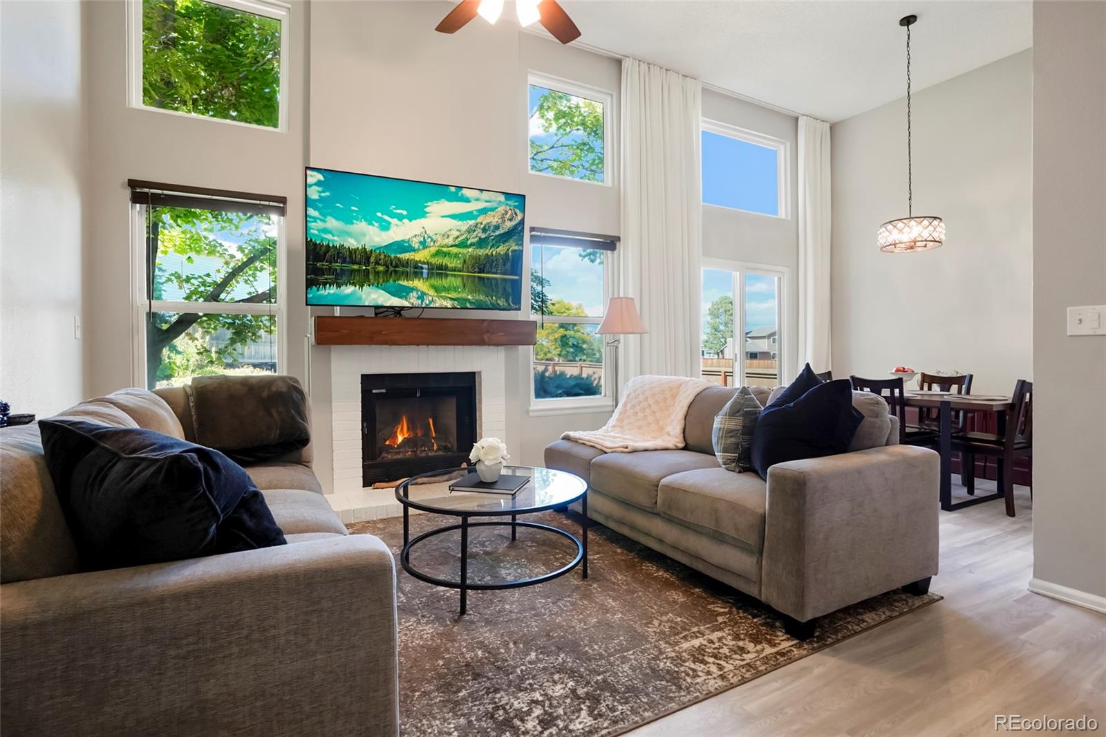 9191 Hickory Circle Highlands Ranch, CO 80126 - Photo 5 of 27 a living room with furniture a large window and a fireplace