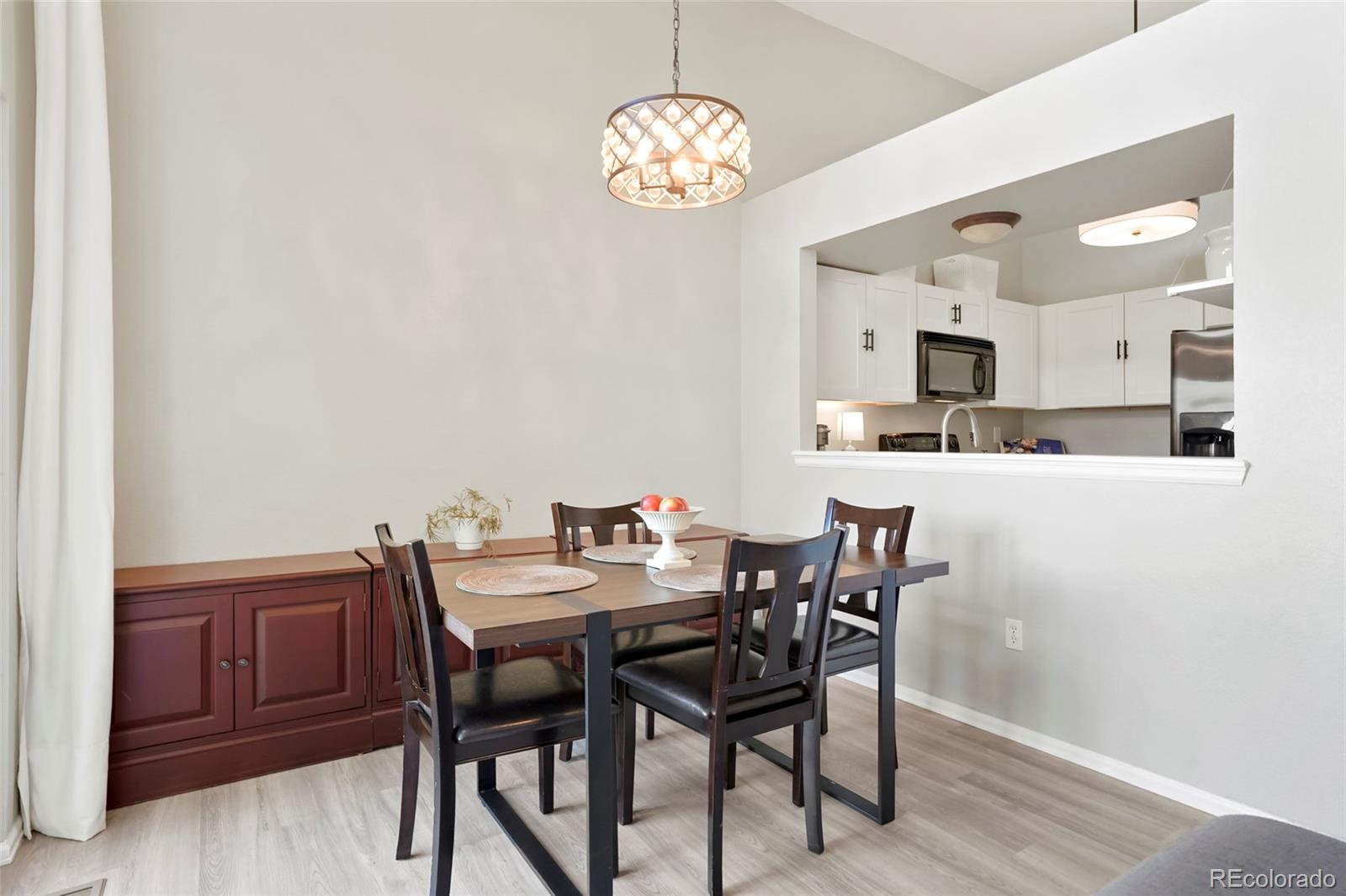 9191 Hickory Circle Highlands Ranch, CO 80126 - Photo 7 of 27 a view of a dining room with furniture and wooden floor