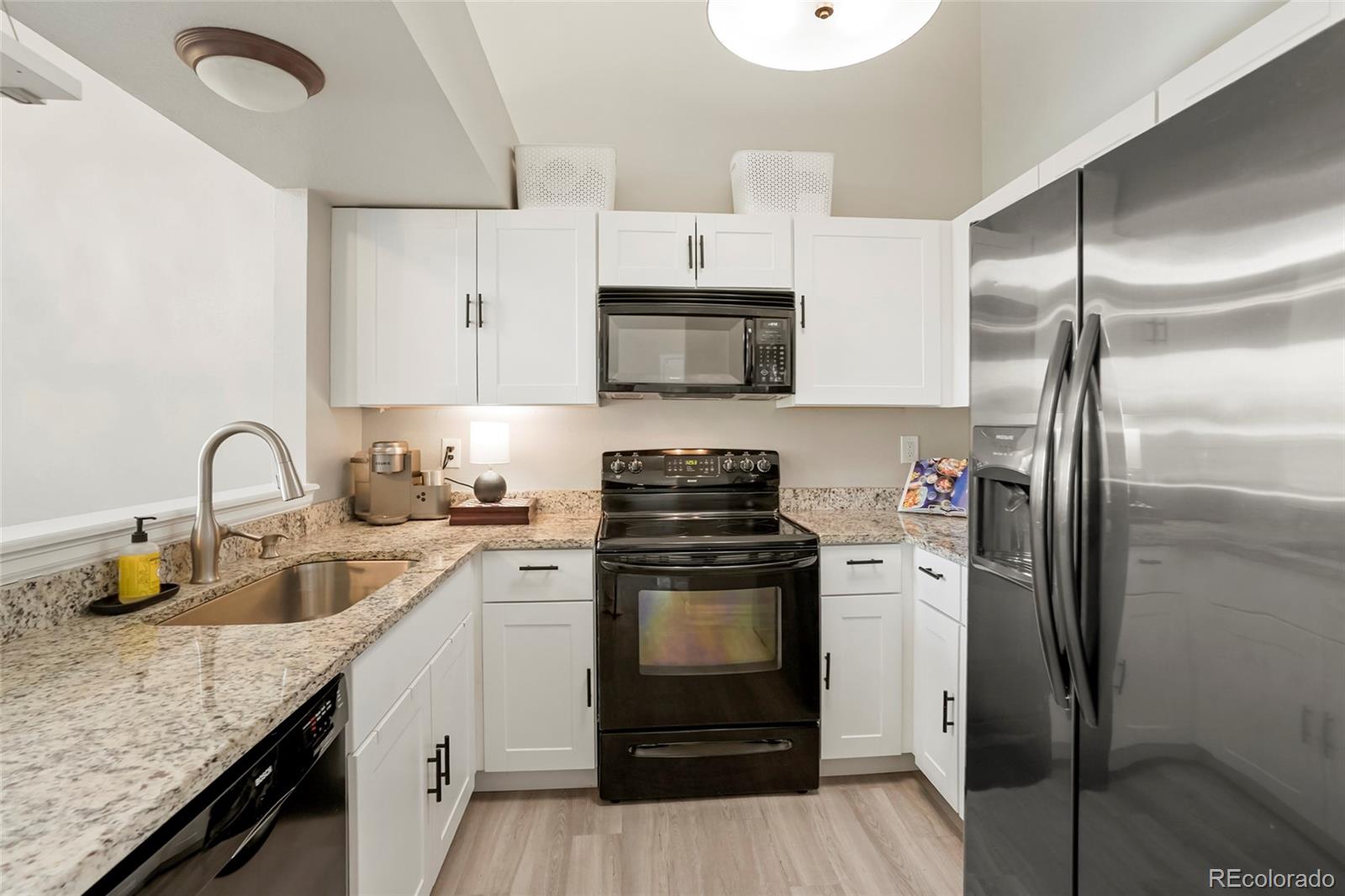 9191 Hickory Circle Highlands Ranch, CO 80126 - Photo 10 of 27 a kitchen with a sink stove and refrigerator
