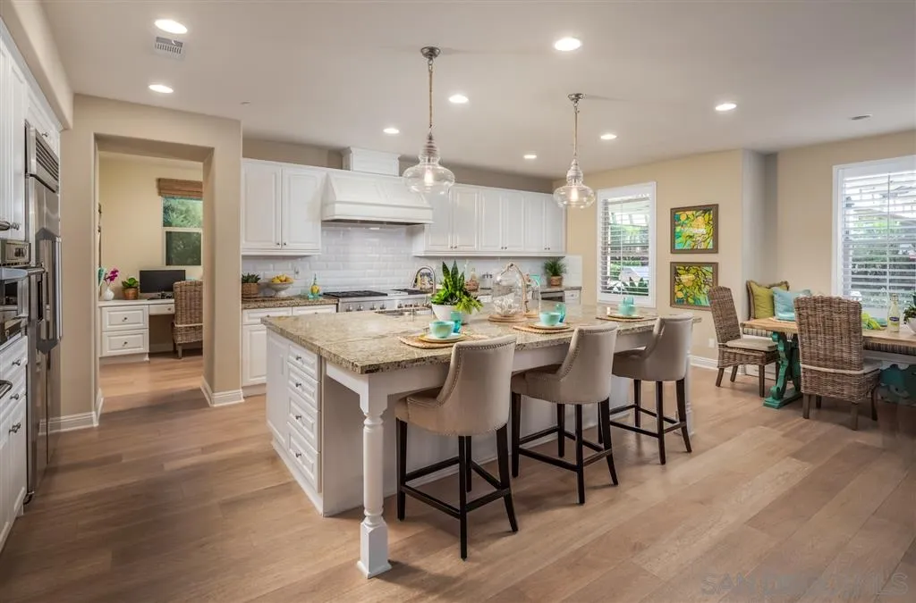 757 Blossom Road Encinitas, CA 92024 - Photo 8 of 25 a kitchen with cabinets table and chairs
