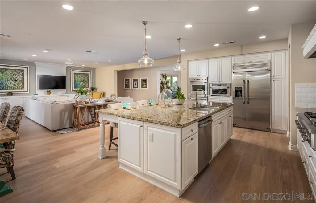 757 Blossom Road Encinitas, CA 92024 - Photo 9 of 25 a kitchen with stainless steel appliances granite countertop a sink stove and refrigerator