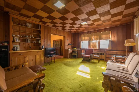 a dining room with furniture a chandelier and wooden floor