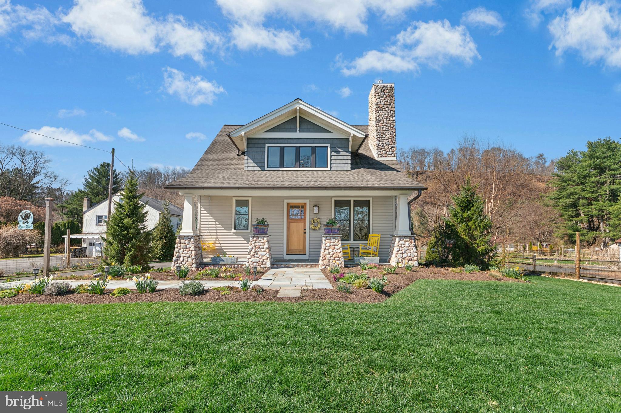 1235 River Road Upper Black Eddy, PA 18972 - Photo 1 of 41 a front view of a house with a garden and plants
