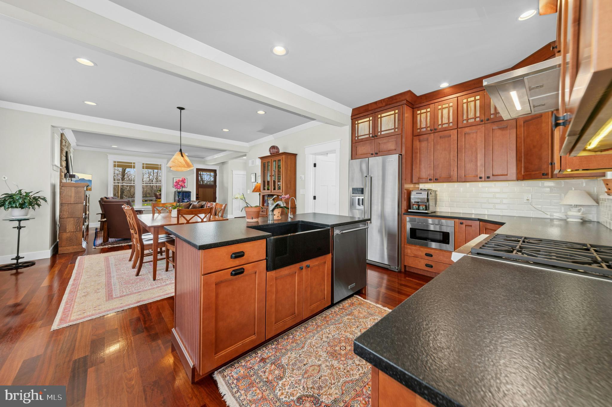 1235 River Road Upper Black Eddy, PA 18972 - Photo 17 of 41 a kitchen with stainless steel appliances kitchen island granite countertop a table chairs in it and wooden floors