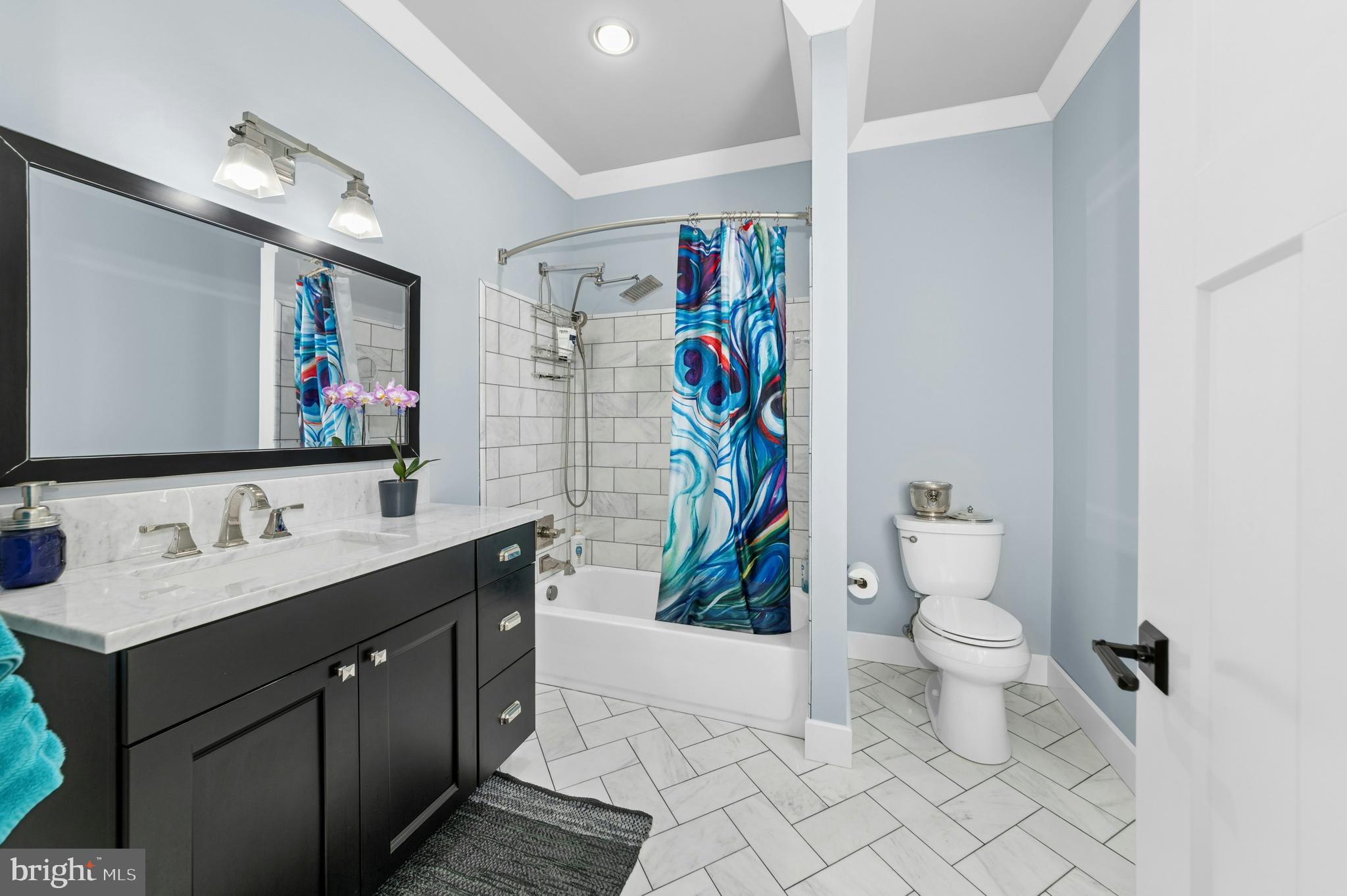 1235 River Road Upper Black Eddy, PA 18972 - Photo 21 of 41 a bathroom with a sink a toilet and a shower curtain