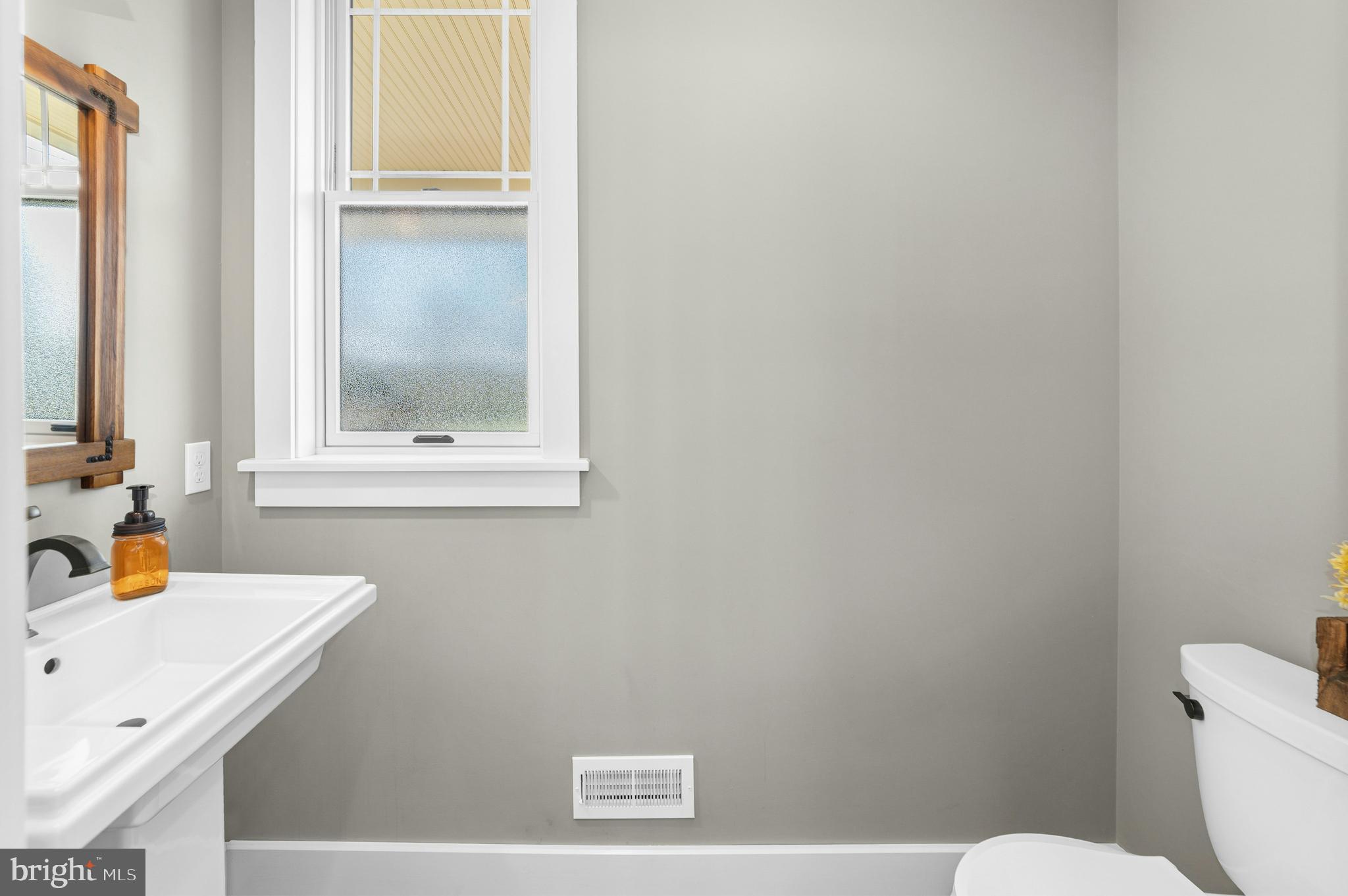 1235 River Road Upper Black Eddy, PA 18972 - Photo 24 of 41 a bathroom with a sink a toilet and a window