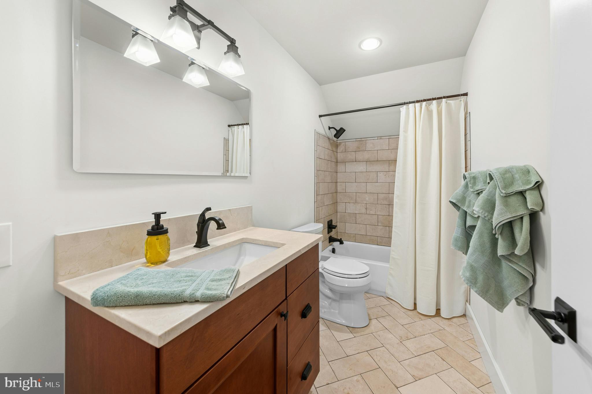 1235 River Road Upper Black Eddy, PA 18972 - Photo 30 of 41 a bathroom with a granite countertop sink a toilet a mirror and shower