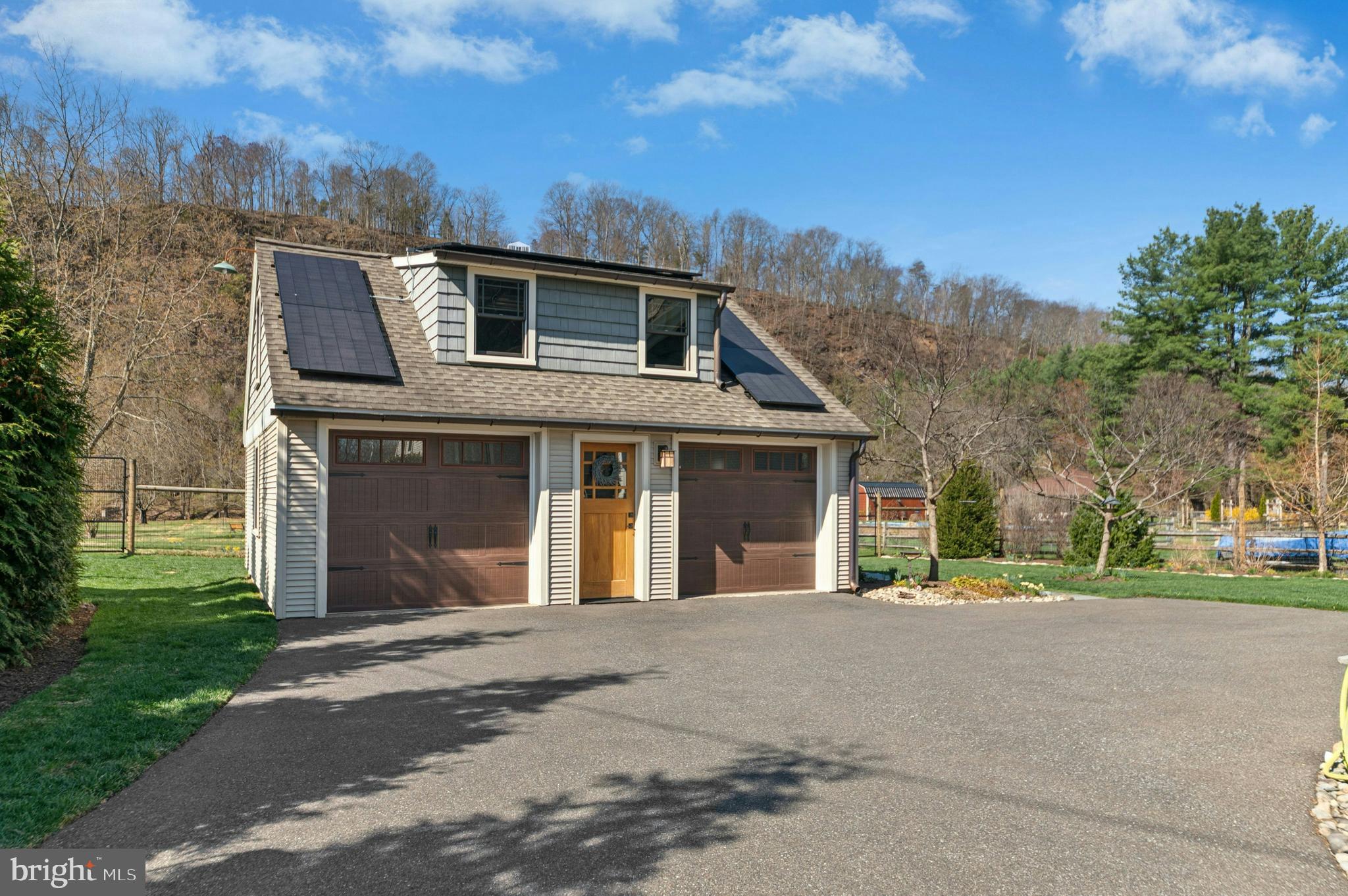1235 River Road Upper Black Eddy, PA 18972 - Photo 4 of 41 a front view of a house with a yard and garage