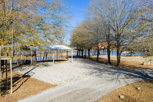 a view of a large white house with a yard covered in snow