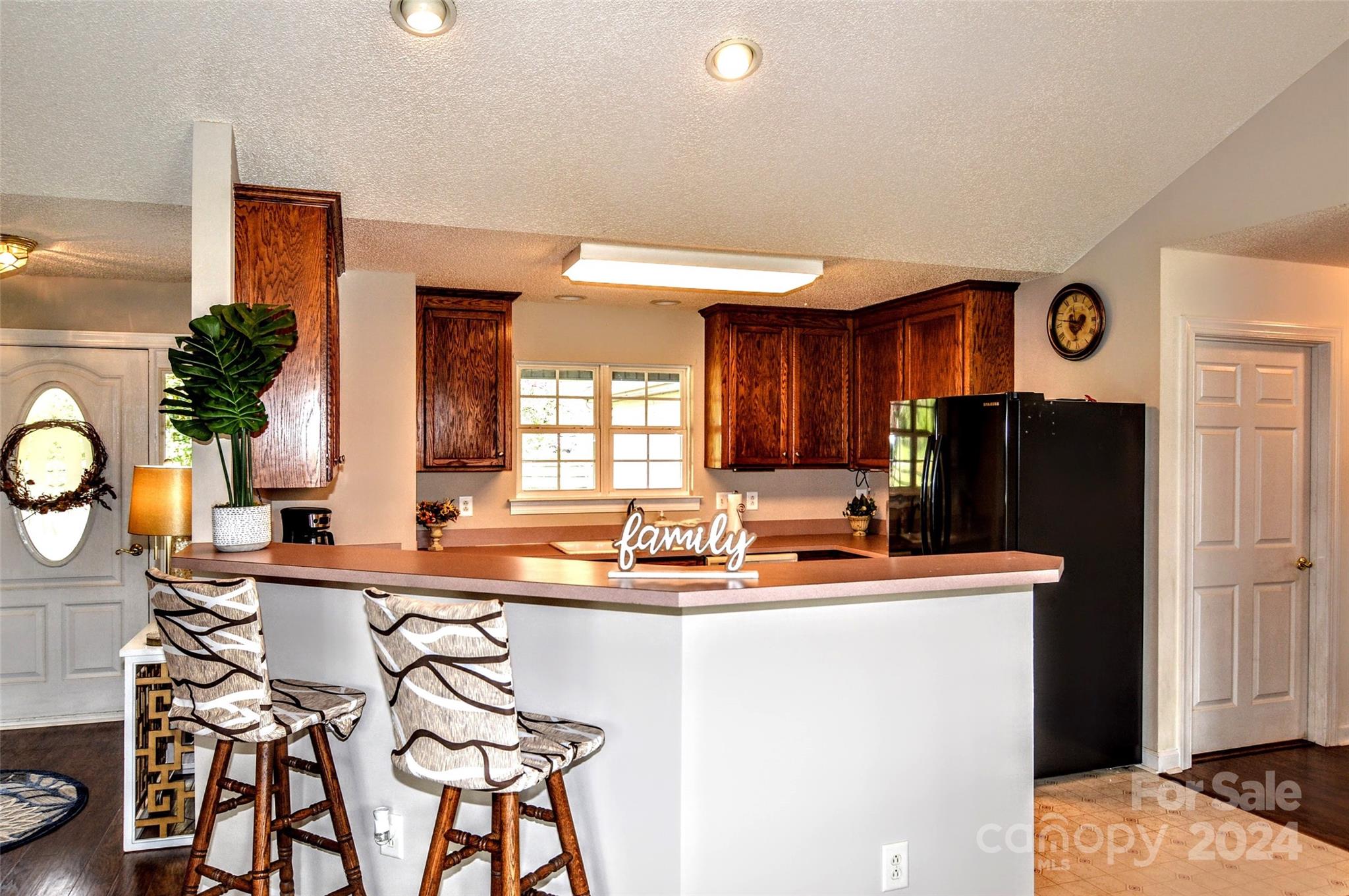 5713 Griffith Road Monroe, NC 28112 - Photo 19 of 48 a dining room with granite countertop a sink and a refrigerator