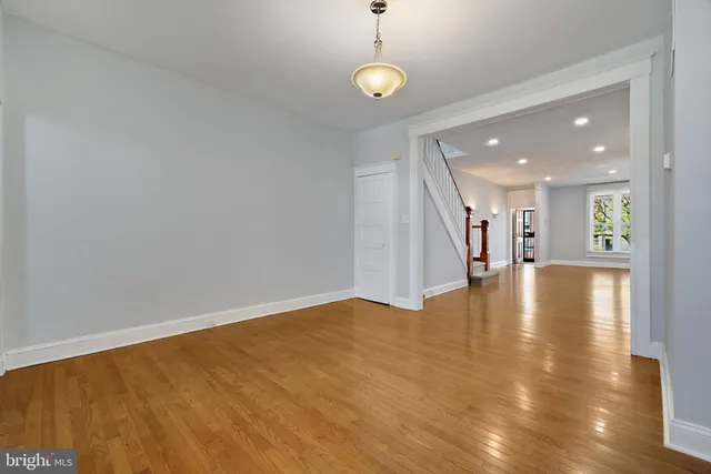 a view of a room with wooden floor