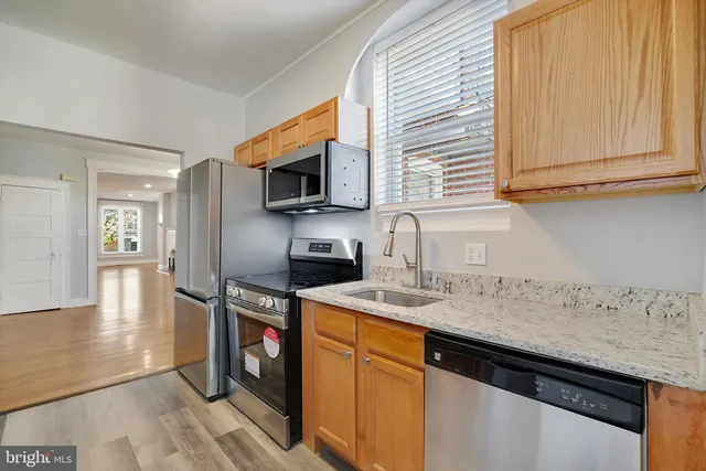 a kitchen with a sink microwave and stove