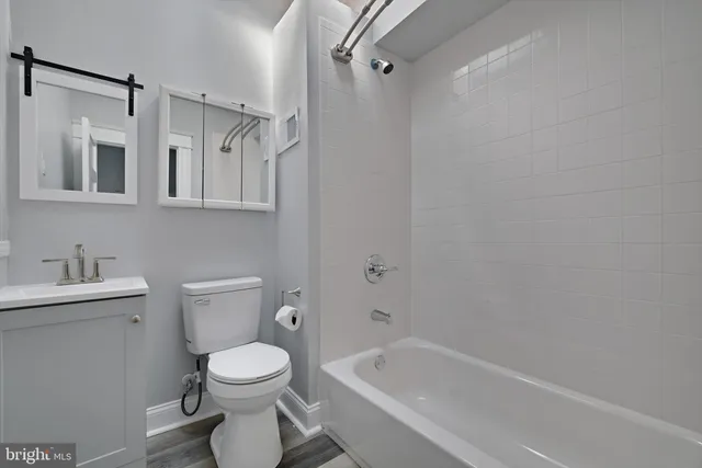 a bathroom with a toilet sink and shower