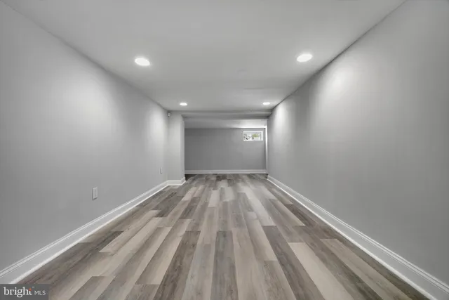 a view of room with wooden floor and window