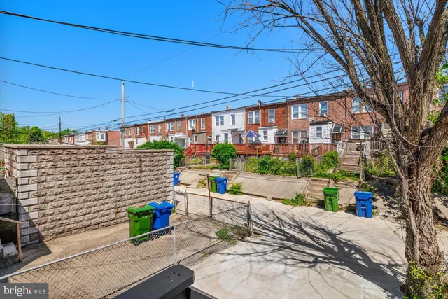 a patio with glass top table and chairs