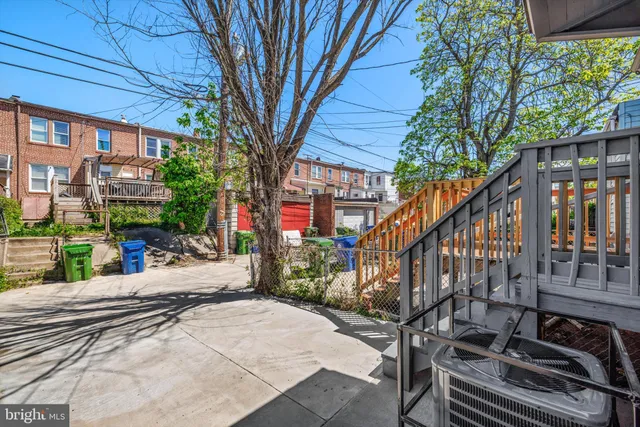 a view of a house with backyard and deck