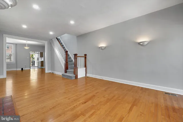a view of an empty room with wooden floor