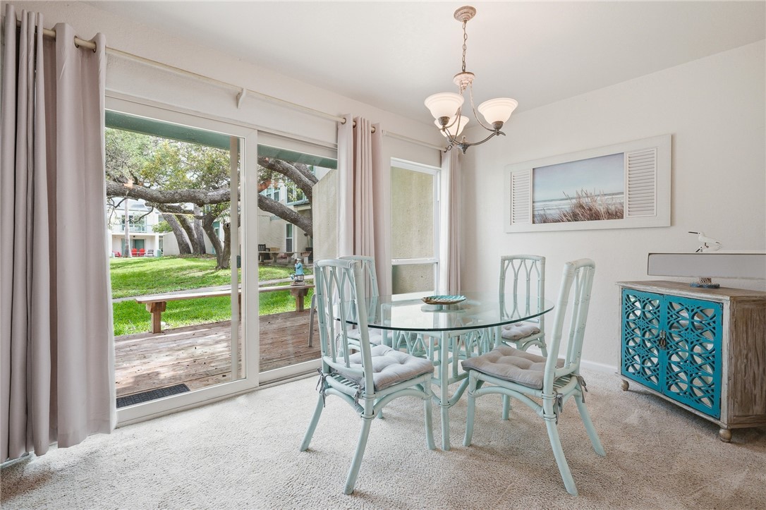 2003 North Fulton Beach Road, Unit 34 34 Rockport, TX 78382 - Photo 7 of 38 a dining room with furniture and a floor to ceiling window