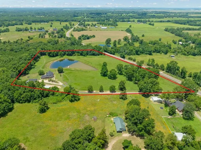 an aerial view of lake residential houses with outdoor space and swimming pool