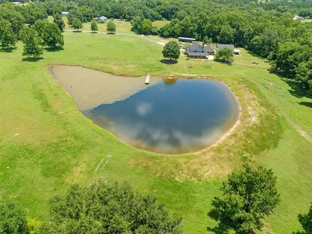 a view of a swimming pool with a yard