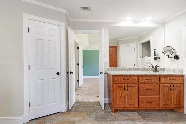 a spacious bathroom with a granite countertop sink and a mirror