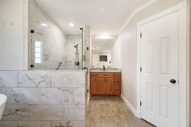 a bathroom with a double vanity sink a mirror and a shower
