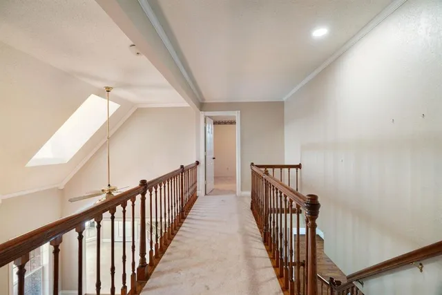 a view of a hallway with wooden floor and entryway