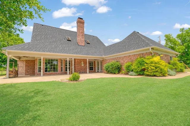 a front view of a house with a yard table and chairs