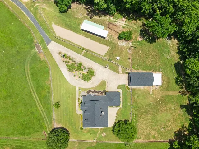 an aerial view of a residential houses with outdoor space