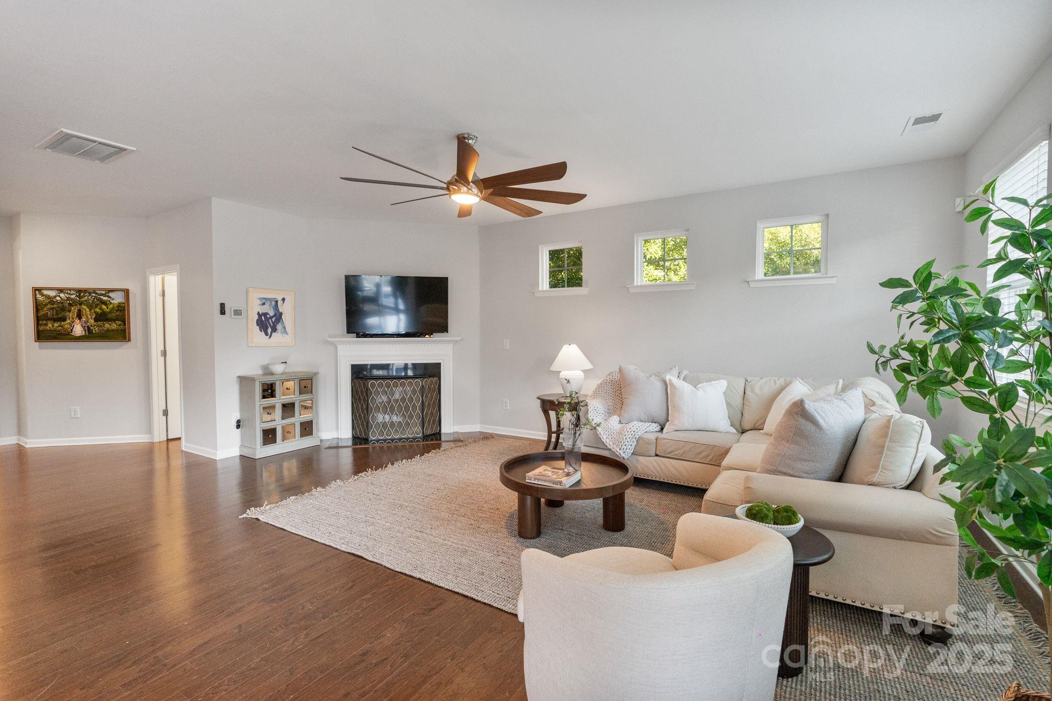 2005 Brightflower Lane York, SC 29745 - Photo 13 of 48 a living room with furniture a fireplace and a flat screen tv