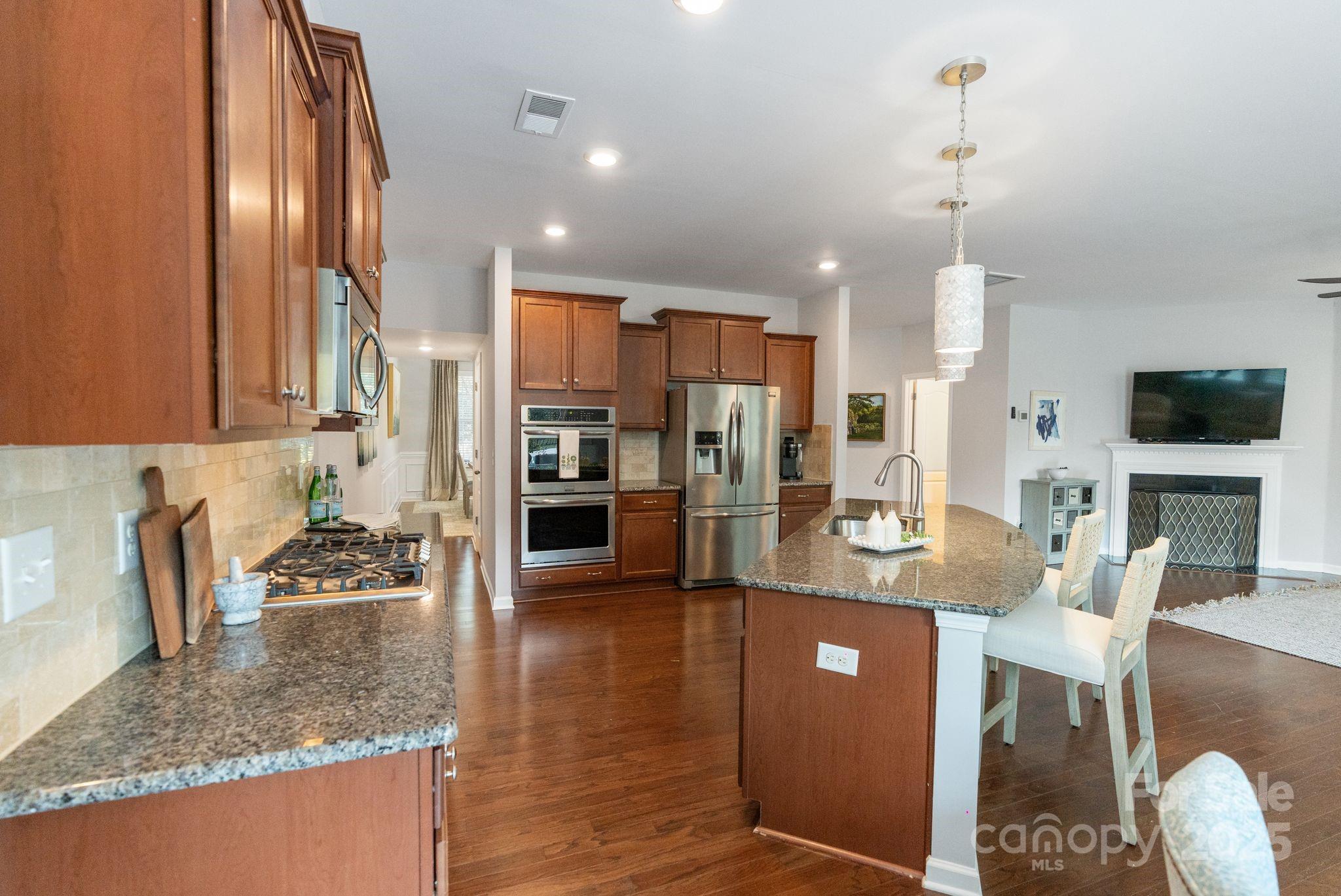 2005 Brightflower Lane York, SC 29745 - Photo 18 of 48 a kitchen with stainless steel appliances granite countertop a stove refrigerator and cabinets