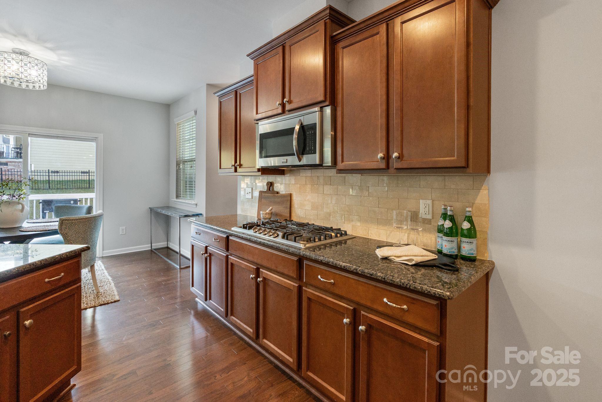2005 Brightflower Lane York, SC 29745 - Photo 21 of 48 a kitchen with stainless steel appliances granite countertop a stove a sink and a microwave