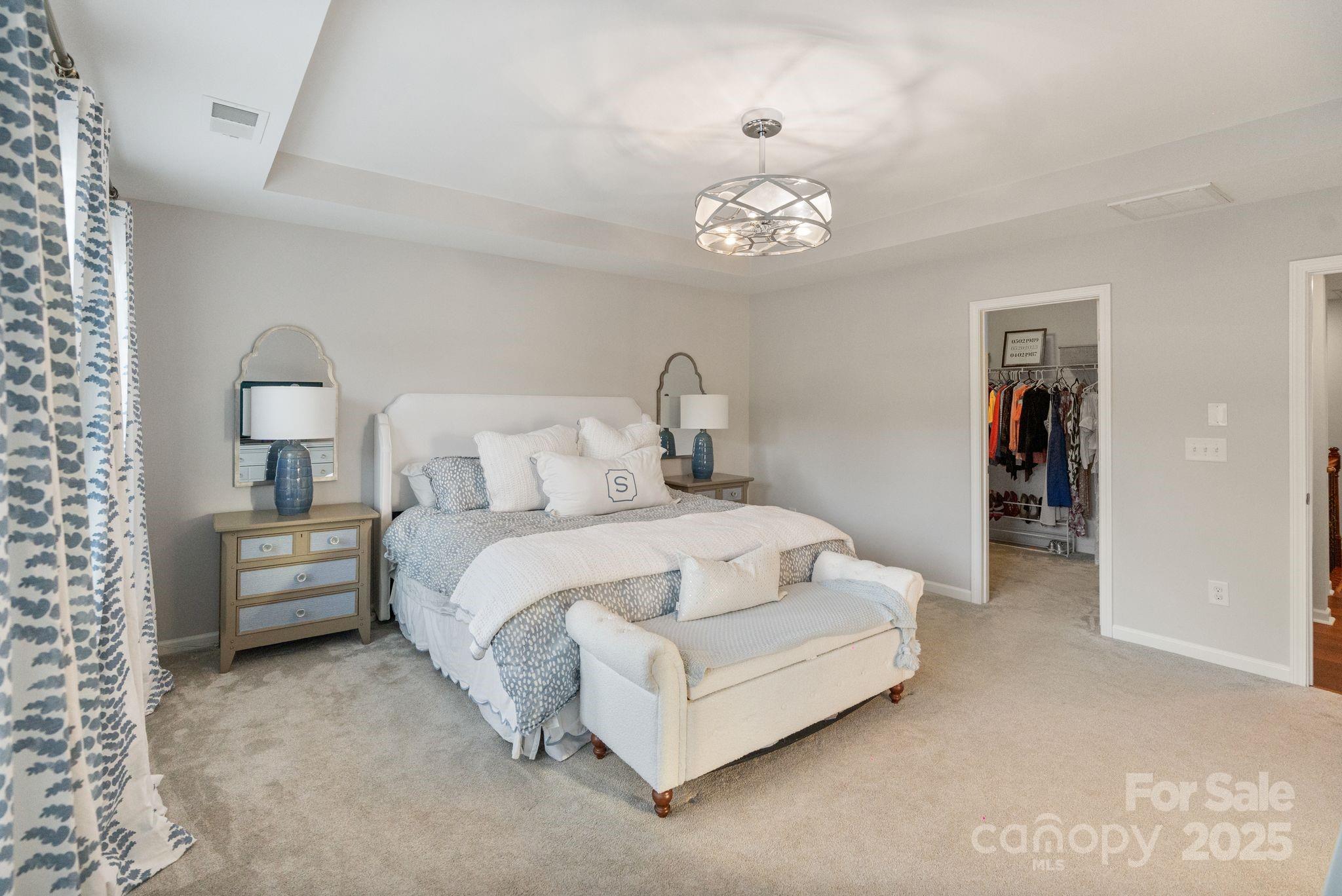 2005 Brightflower Lane York, SC 29745 - Photo 30 of 48 a bedroom with a bed and a chandelier