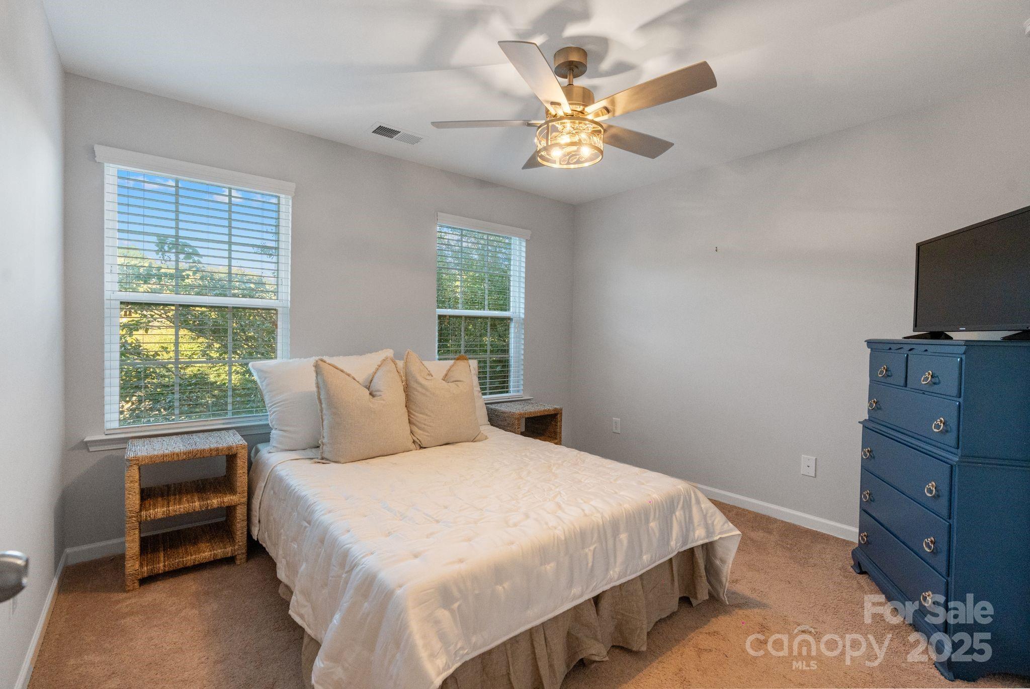 2005 Brightflower Lane York, SC 29745 - Photo 35 of 48 a bedroom with a bed and a chandelier