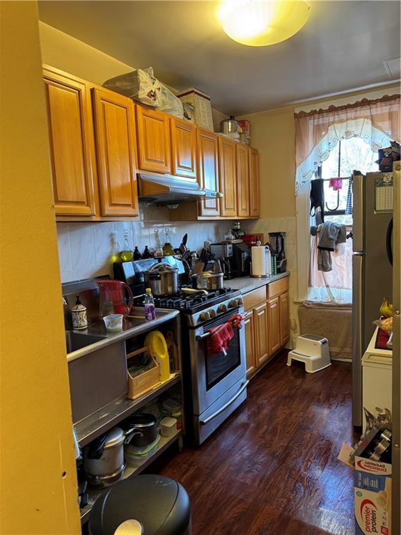 7215 3rd Avenue Brooklyn, NY 11209 - Photo 7 of 10 a kitchen with stainless steel appliances a stove a sink wooden floor and cabinets