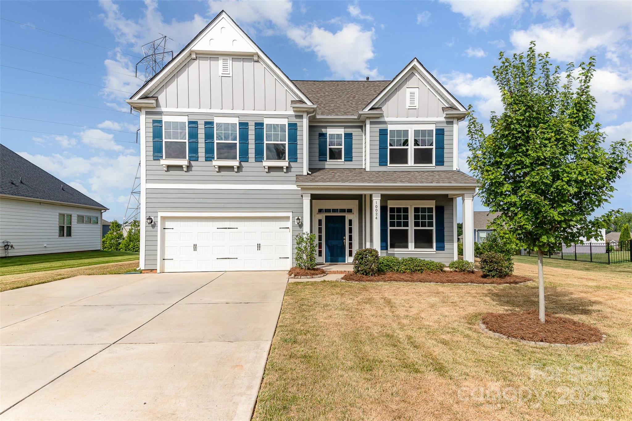 10024 Fox Trotter Lane Midland, NC 28107 - Photo 1 of 43 a front view of a house with a yard and garage