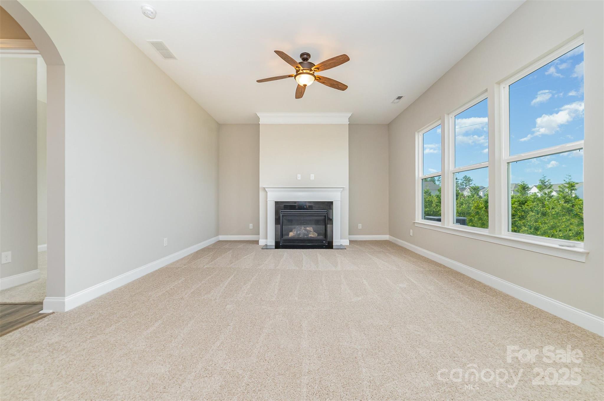 10024 Fox Trotter Lane Midland, NC 28107 - Photo 11 of 43 a view of an empty room with a fireplace and a window