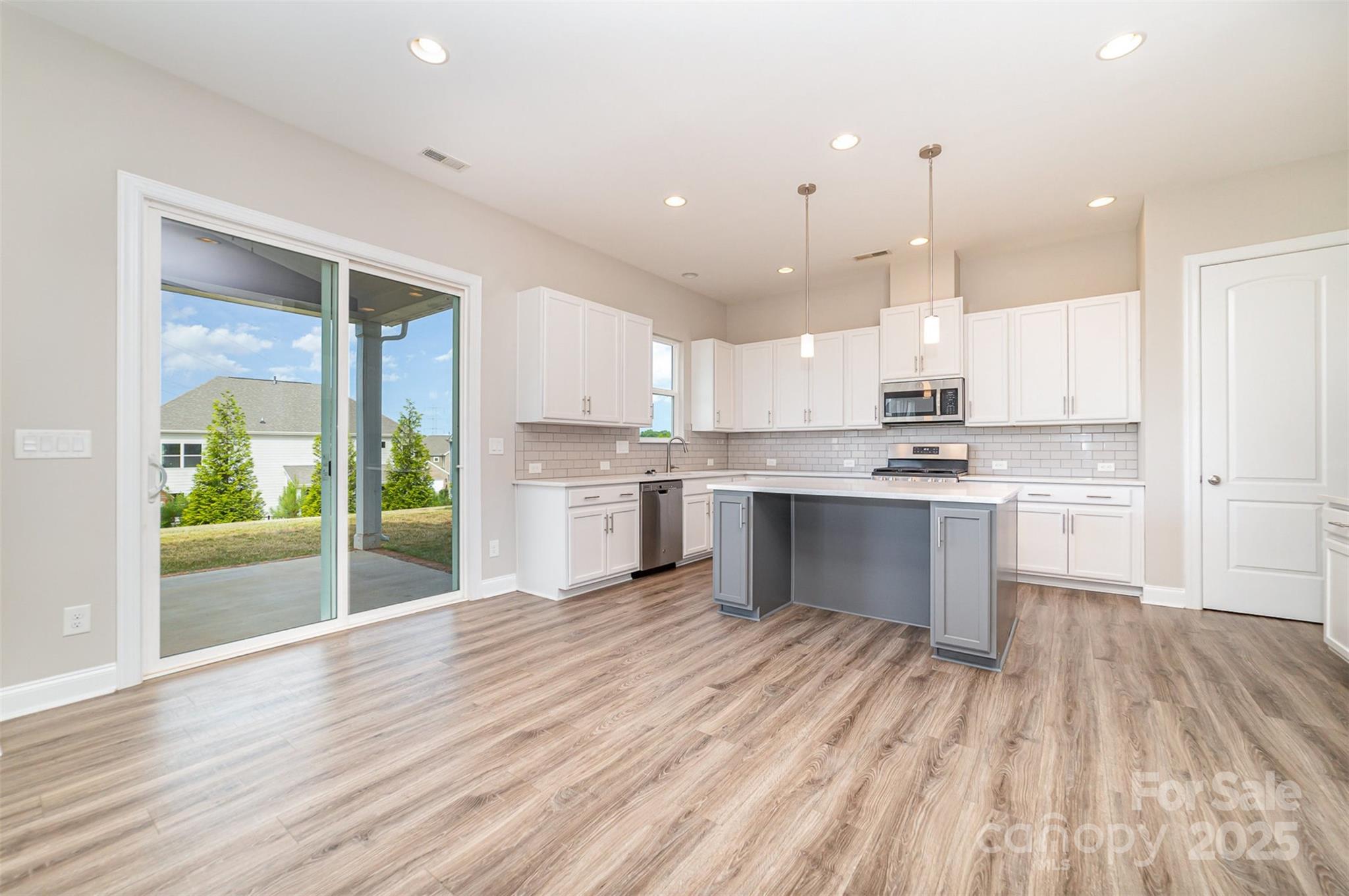 10024 Fox Trotter Lane Midland, NC 28107 - Photo 15 of 43 a large kitchen with kitchen island a sink stainless steel appliances and cabinets