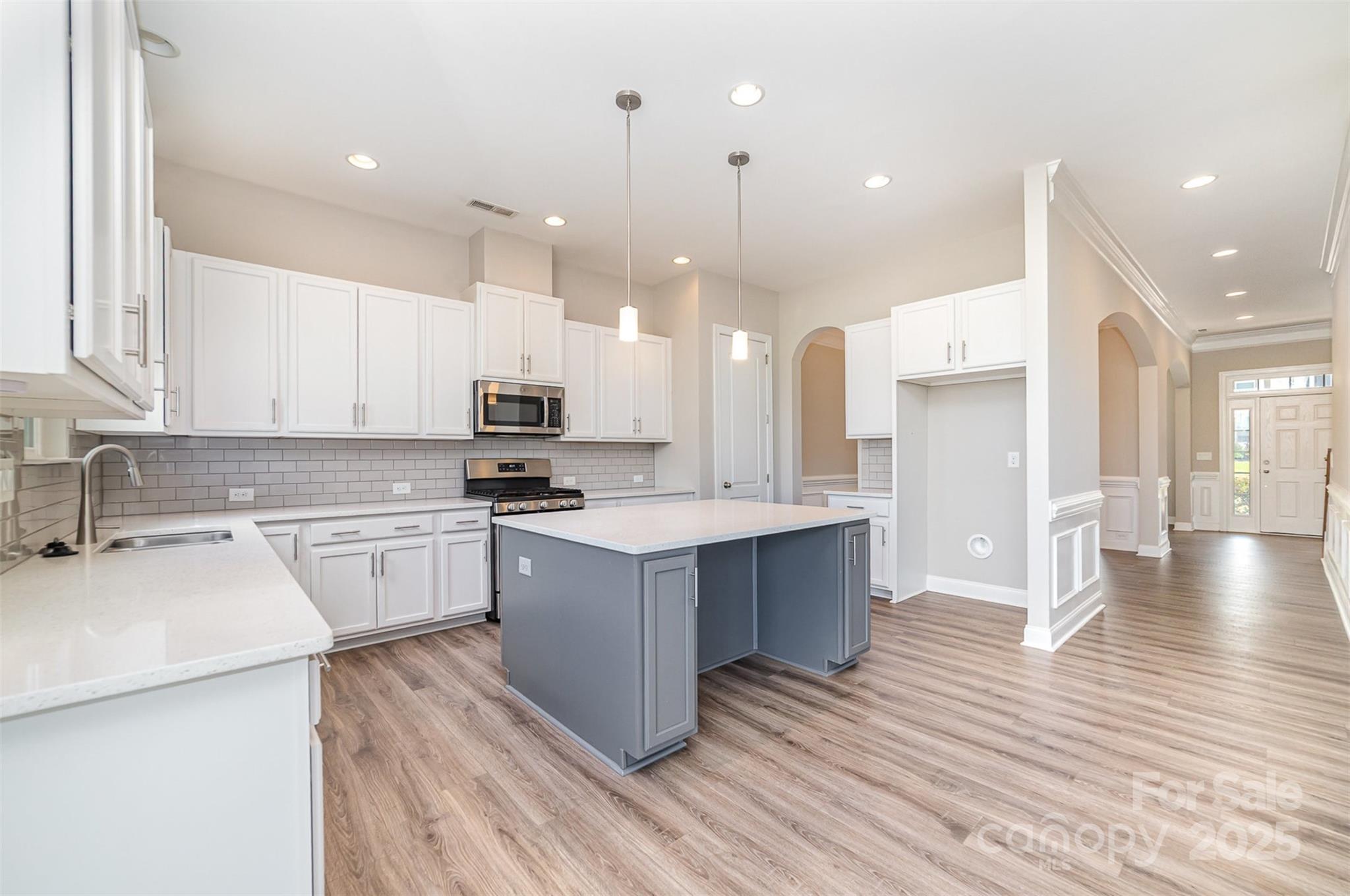 10024 Fox Trotter Lane Midland, NC 28107 - Photo 16 of 43 a kitchen with a sink wooden floor stainless steel appliances and cabinets
