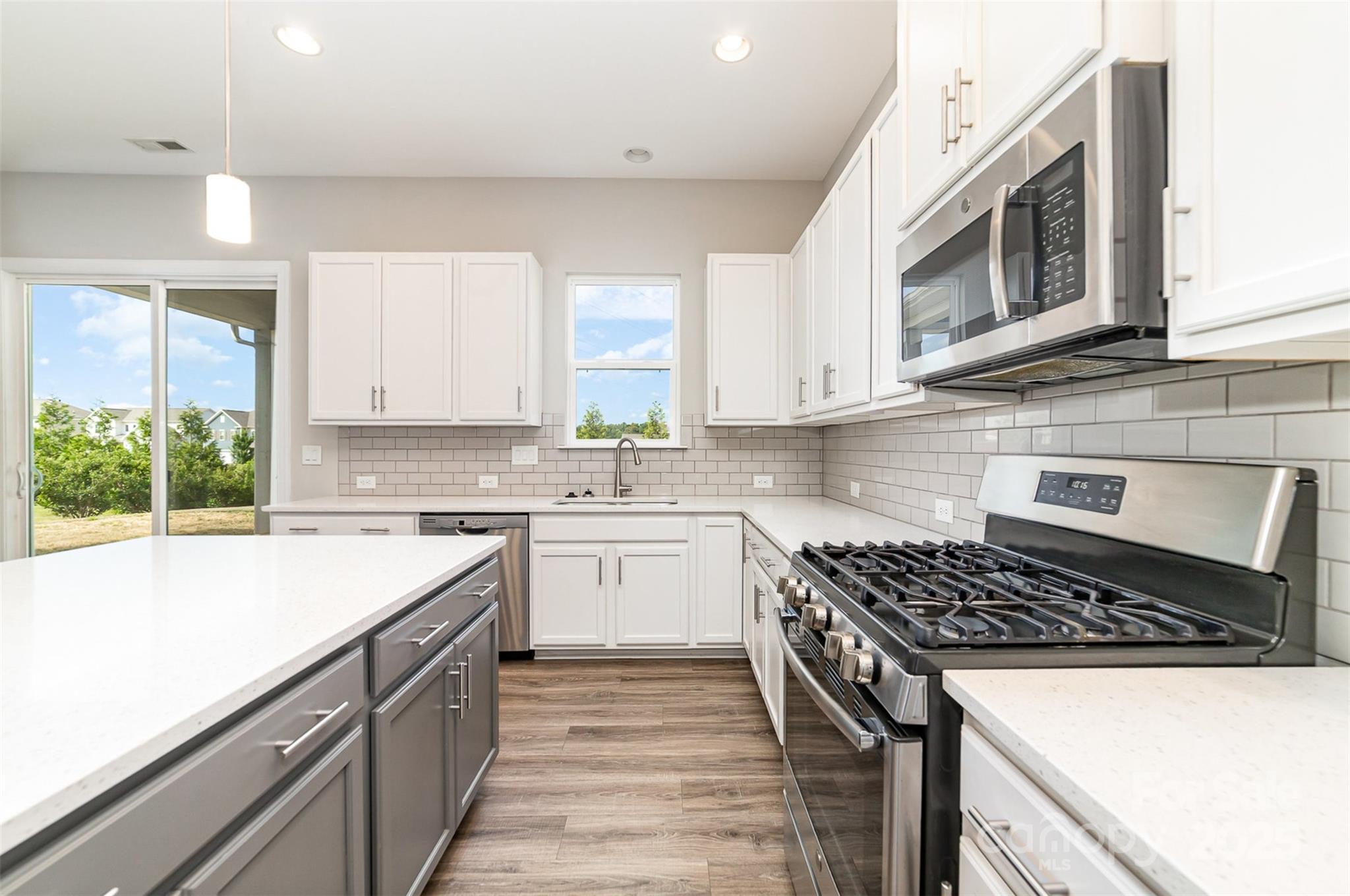10024 Fox Trotter Lane Midland, NC 28107 - Photo 19 of 43 a kitchen with a sink stove top oven and cabinets
