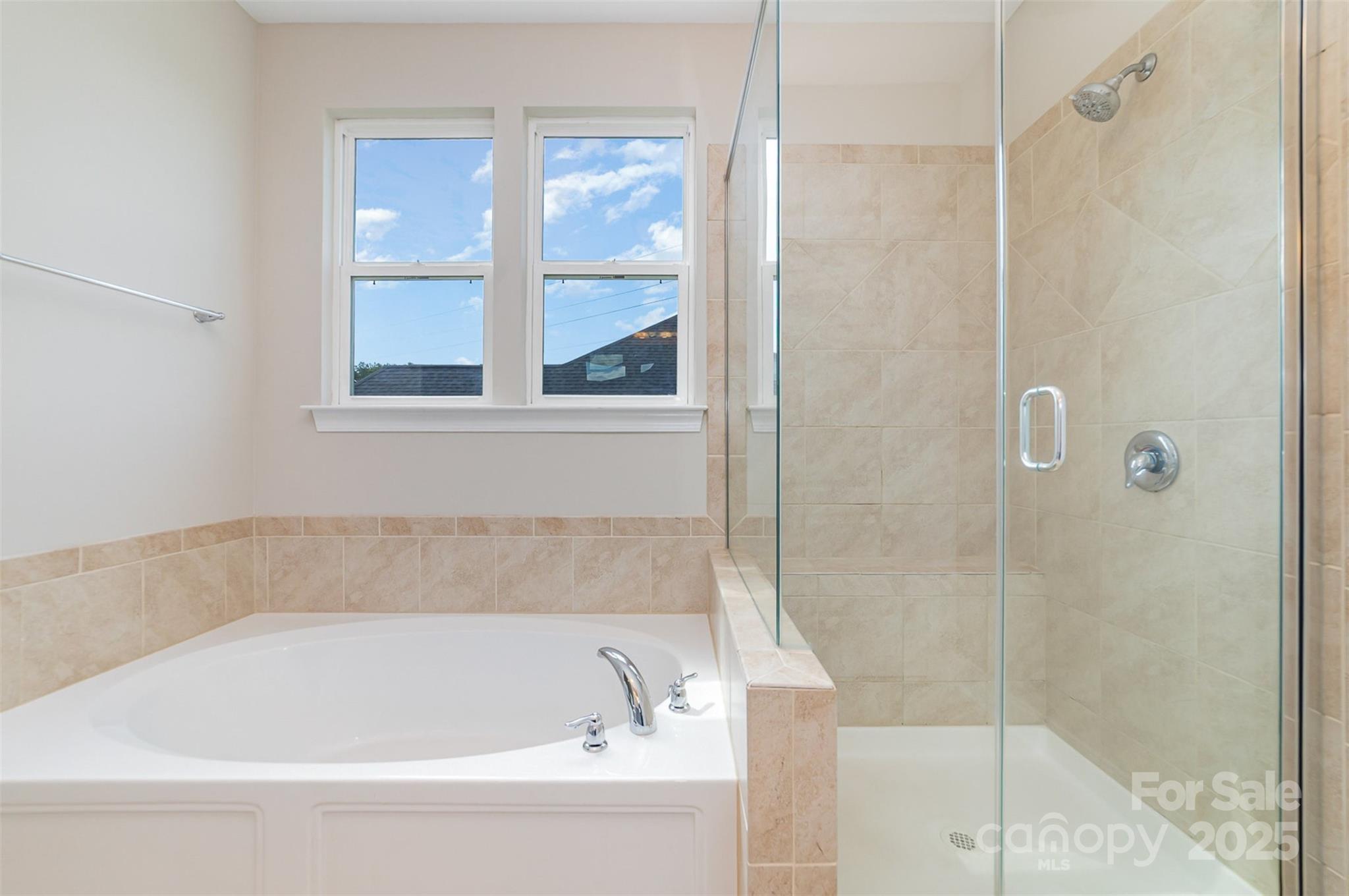 10024 Fox Trotter Lane Midland, NC 28107 - Photo 26 of 43 a bathroom with a bathtub and shower