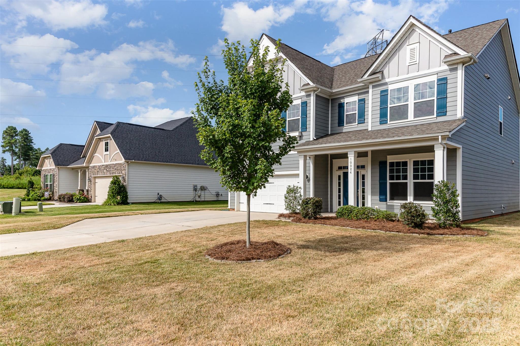 10024 Fox Trotter Lane Midland, NC 28107 - Photo 3 of 43 a front view of a house with a yard and garage