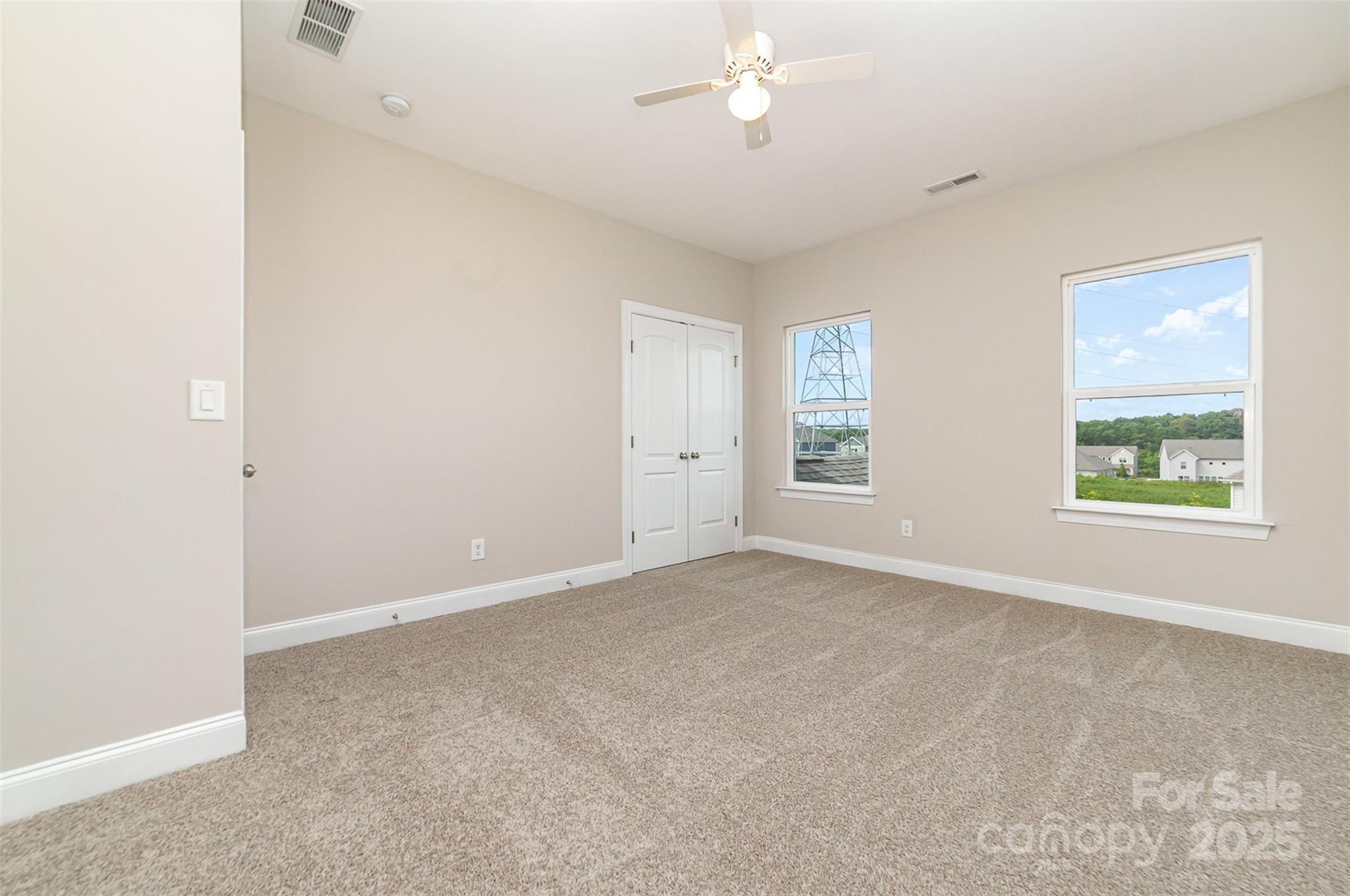 10024 Fox Trotter Lane Midland, NC 28107 - Photo 31 of 43 an empty room with a window and a ceiling fan