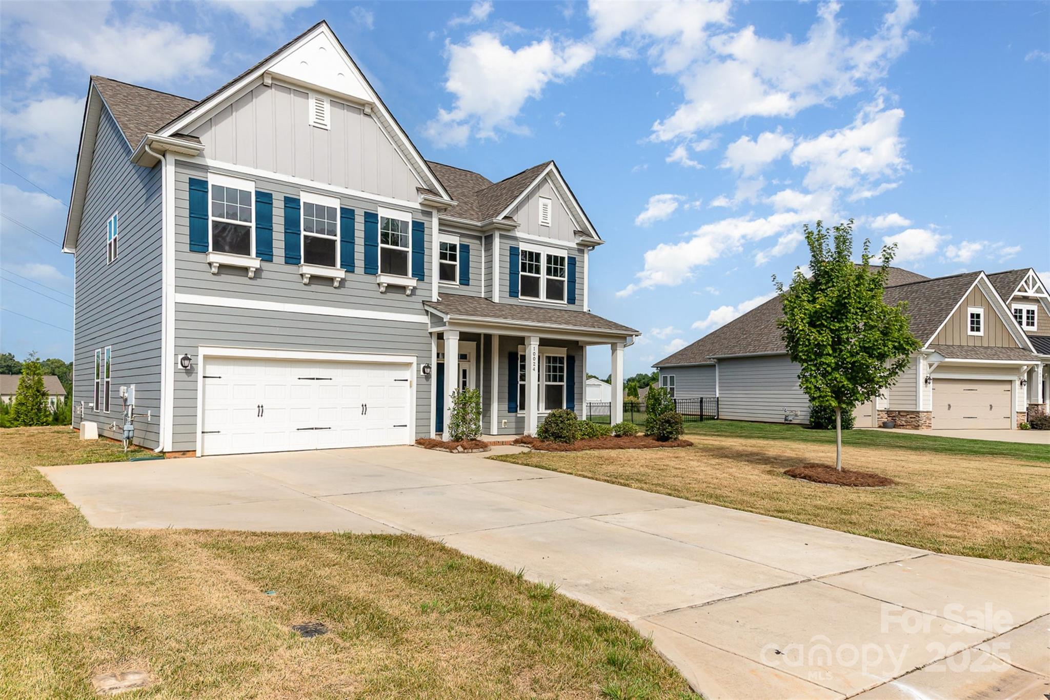 10024 Fox Trotter Lane Midland, NC 28107 - Photo 4 of 43 a front view of a house with a yard and garage