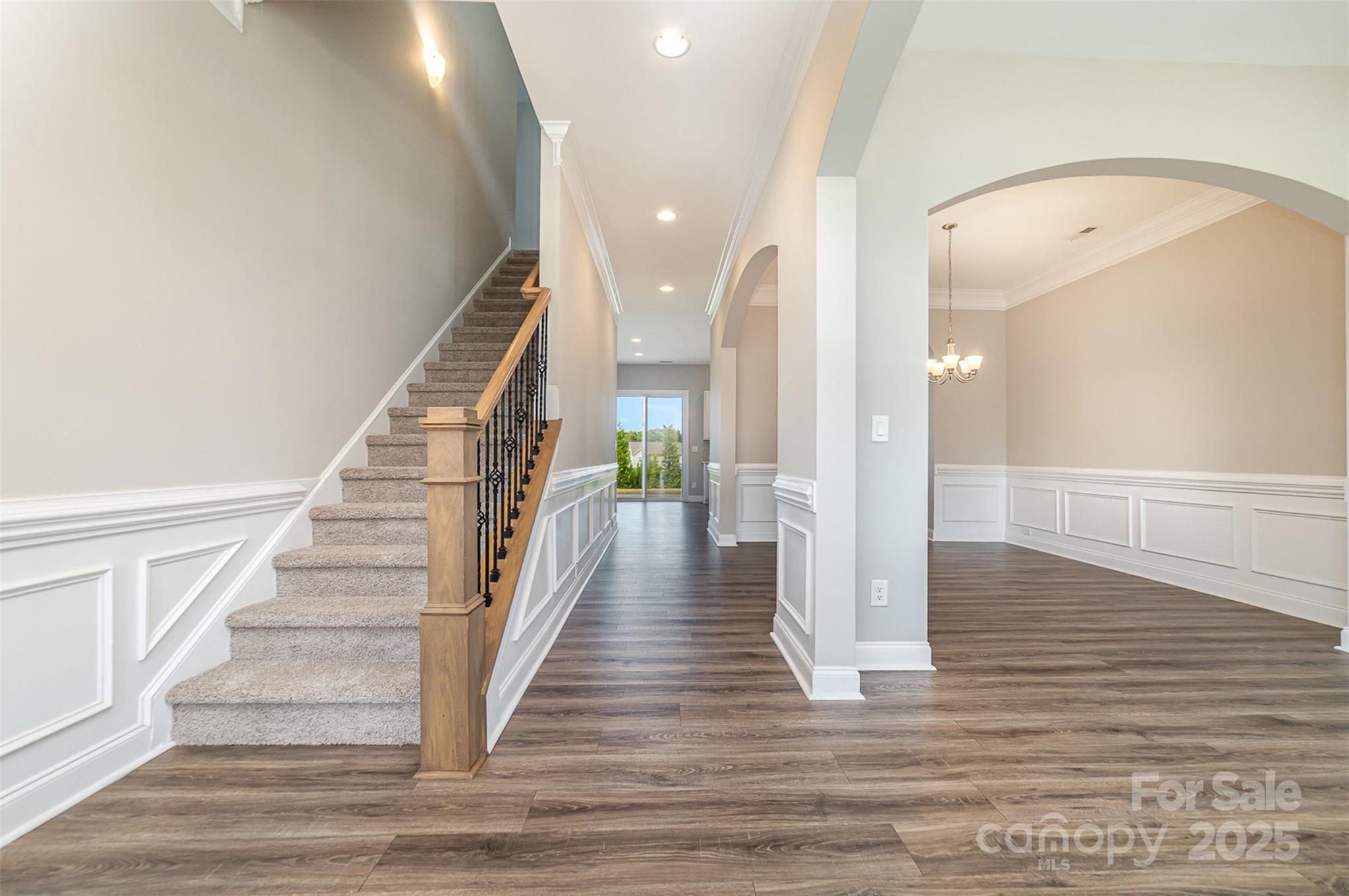10024 Fox Trotter Lane Midland, NC 28107 - Photo 7 of 43 a view of staircase with white walls and wooden floor