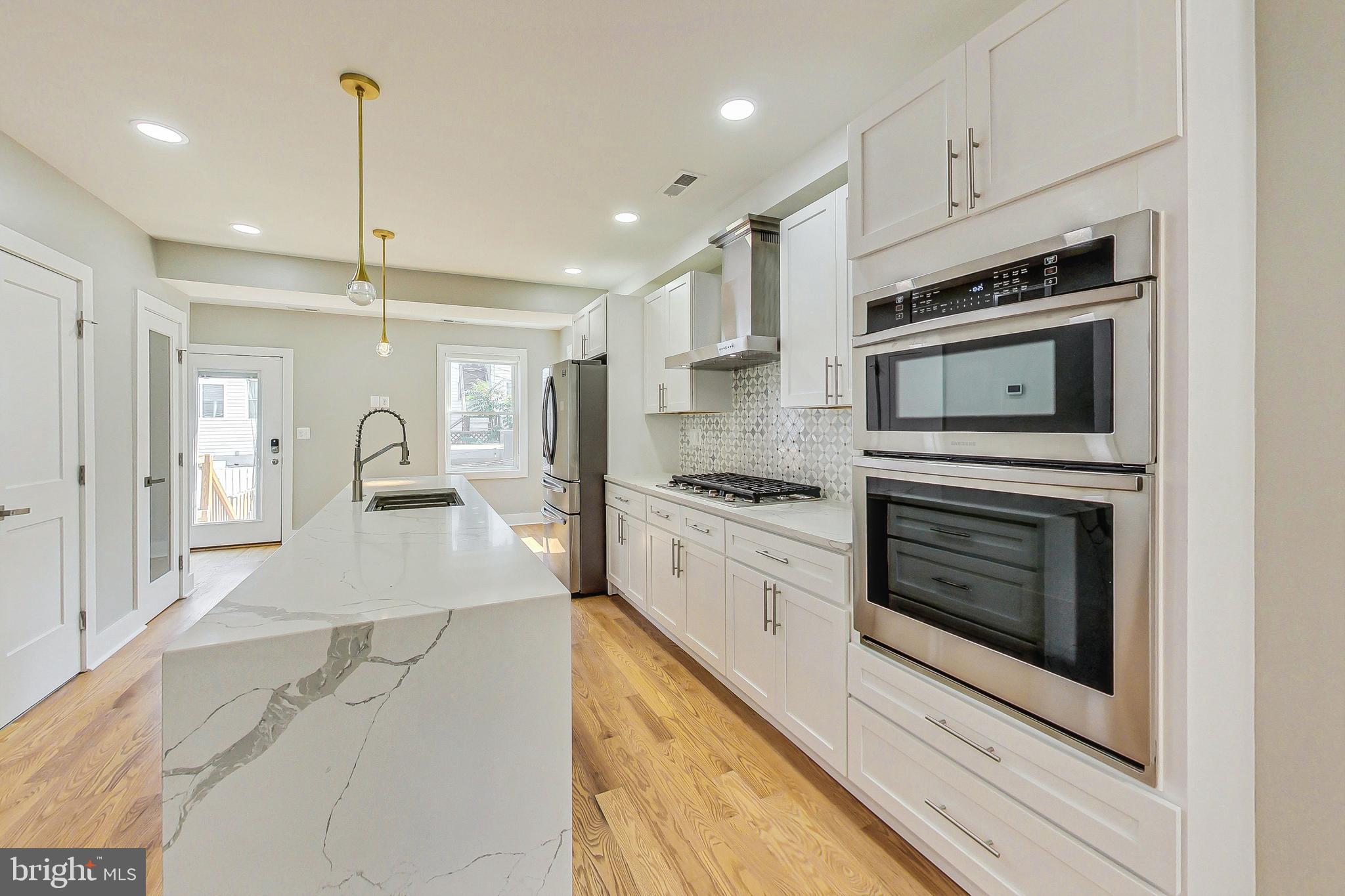 1124 Owen Place Northeast Washington, DC 20002 - Photo 1 of 19 a kitchen with granite countertop a stove and a refrigerator