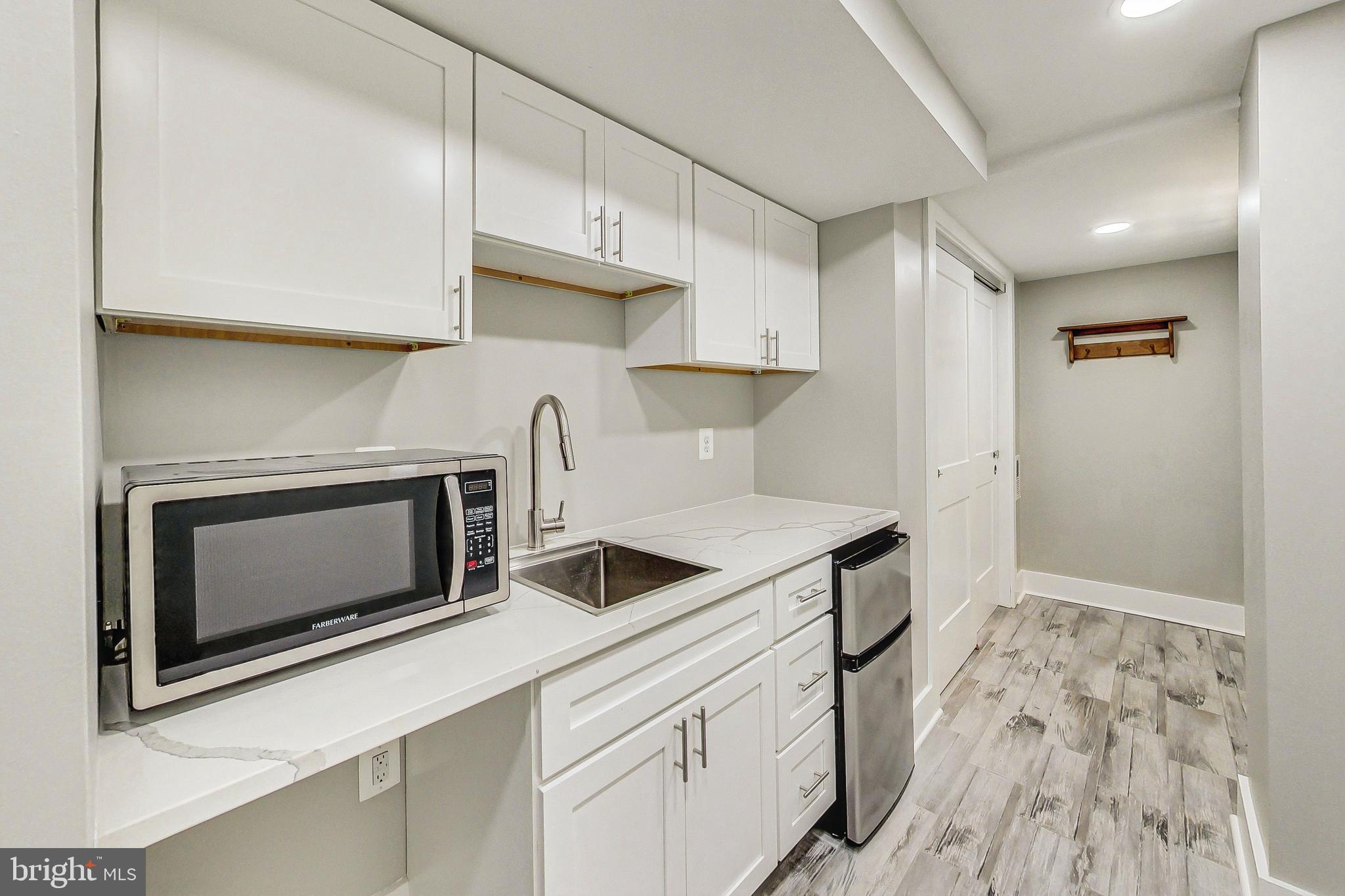 1124 Owen Place Northeast Washington, DC 20002 - Photo 15 of 19 a kitchen with granite countertop a stove and a sink