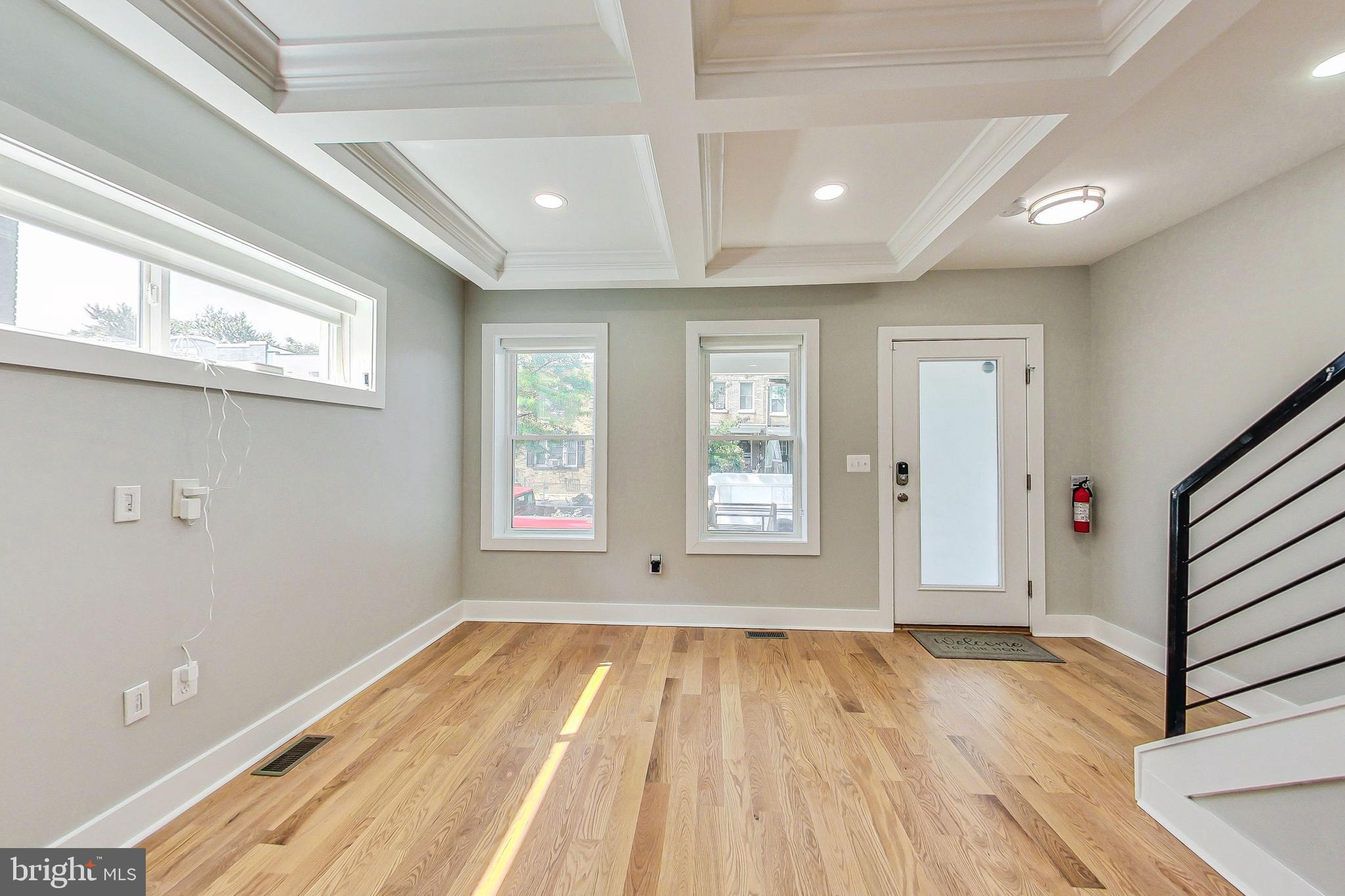 1124 Owen Place Northeast Washington, DC 20002 - Photo 3 of 19 a view of an empty room with wooden floor and a window